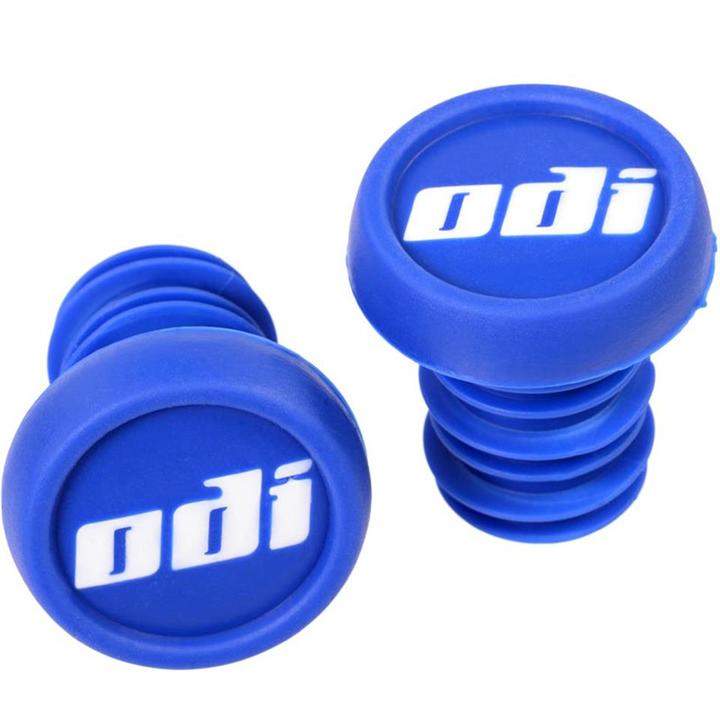 The ODI Push-In Stunt Scooter Bar Ends in blue are branded with "odi" in white text on their top surfaces. These two rubber pieces placed against a white background provide resin protection and allow for color customization.