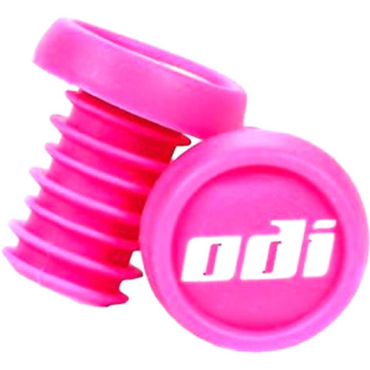 Close-up of two pink ODI handlebar grips, complemented by the ODI Push-In Stunt Scooter Bar Ends for a secure fit. One grip is upright, highlighting its ribbed texture, while the other lays flat to reveal the white "odi" logo on top. Ideal for riders seeking vibrant color customization and dependable grip performance.