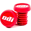 Two red ODI Push-In Stunt Scooter Bar Ends with the "odi" logo in white text, made from durable resin. One bar end is upright while the other leans against it, displaying its threaded side.
