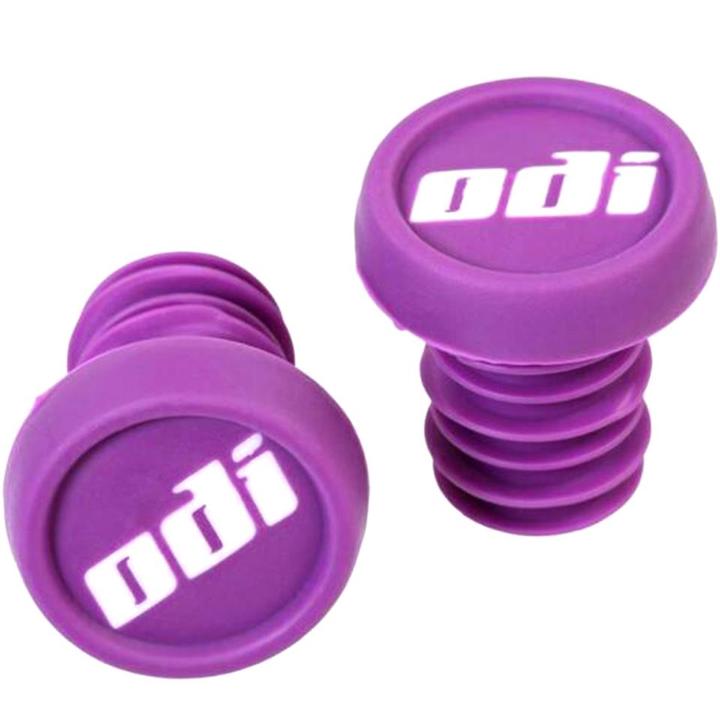 The ODI Push-In Stunt Scooter Bar Ends in purple feature white "odi" branding on the circular end, providing color customization. These rubber bar end caps have grooved stems for easy grip and seamless insertion into handlebars, ensuring a secure fit.
