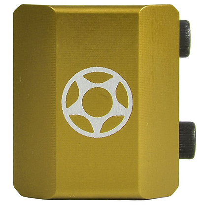 A rectangular device in a gold finish featuring a brushed metal texture, with a white circular star-like design at its center. It includes two black cylindrical components on the right side resembling a sturdy clamp, ideal for enhancing any custom scooter setup. This is the Proto Half Knuckle 2 Bolt Oversized Stunt Scooter Clamp from Proto.