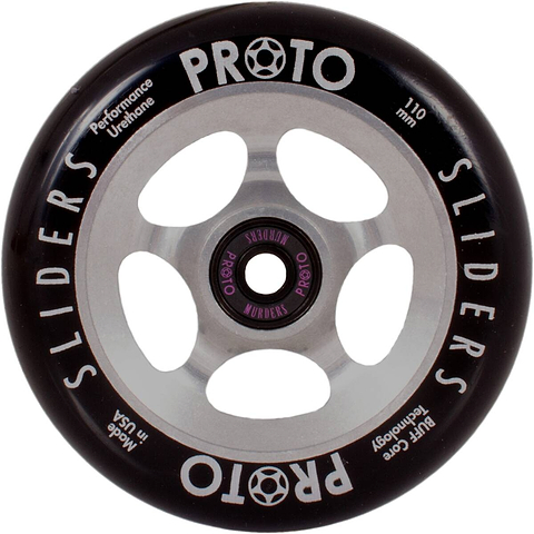 The Proto Sliders 110mm Stunt Scooter Wheel - Raw Silver, featuring Buff Core technology, is a black wheel with silver spokes that highlights "PROTO SLIDERS," "Performance Urethane," and "110 mm" along the edge. Expertly crafted in the USA, this robust design is engineered for exceptional performance.