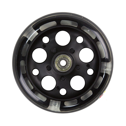 The Zycom 125mm Light Up Front Scooter Wheel in black showcases a design with multiple circular holes and a central metal bearing, complemented by partially translucent tires that feature an intriguing pattern of light and dark sections. This edition is enhanced with captivating light-up LEDs for an eye-catching ride.