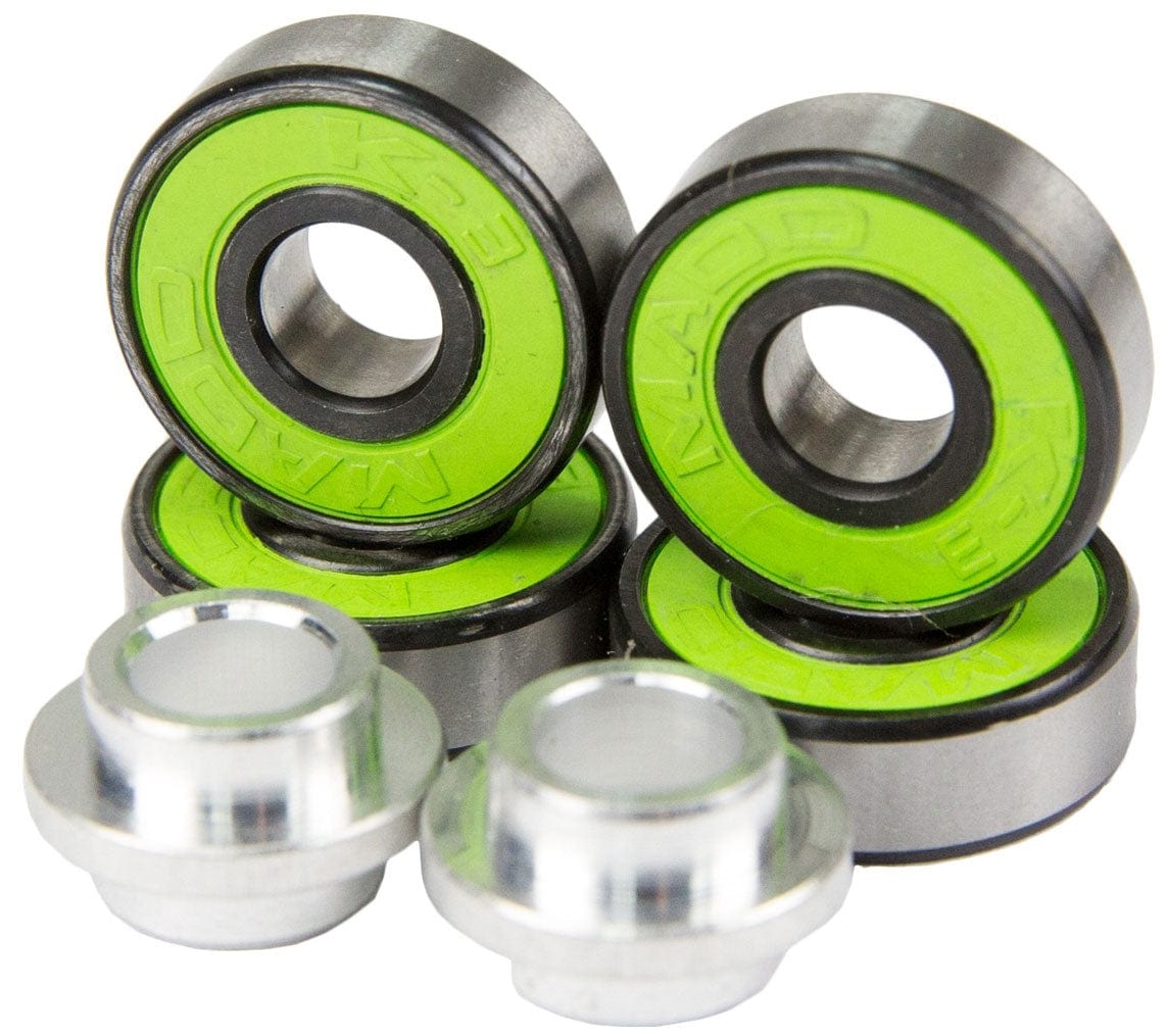 A pack of four Madd Gear MGP K-3 ABEC 11 green scooter bearings is arranged alongside two silver, cylindrical axle spacers. Imprinted with "K3 MAD," these high-precision wheel bearings are showcased in a close-up image with shining components.
