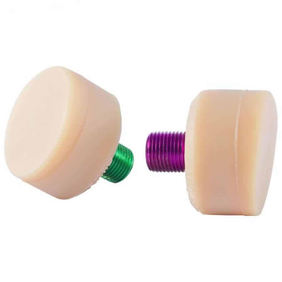 Displayed on a white background are two cylindrical Gumball V2 Natural Toe Stoppers, each with a threaded base—one green and one purple. Both beige stoppers from Gumball ensure excellent skating control and stopping power.