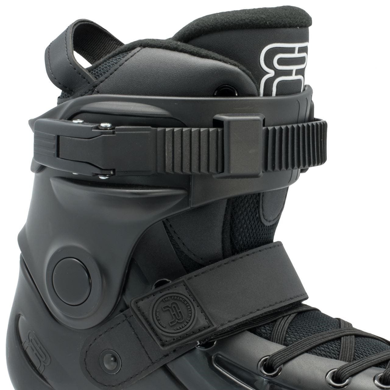Close-up of the FR Skates Junior Adjustable Inline Skate boot in black, showcasing adjustable straps and a padded interior. The design incorporates a buckle, laces, and an embossed logo on the side, paired with durable polyurethane wheels for smooth rides.