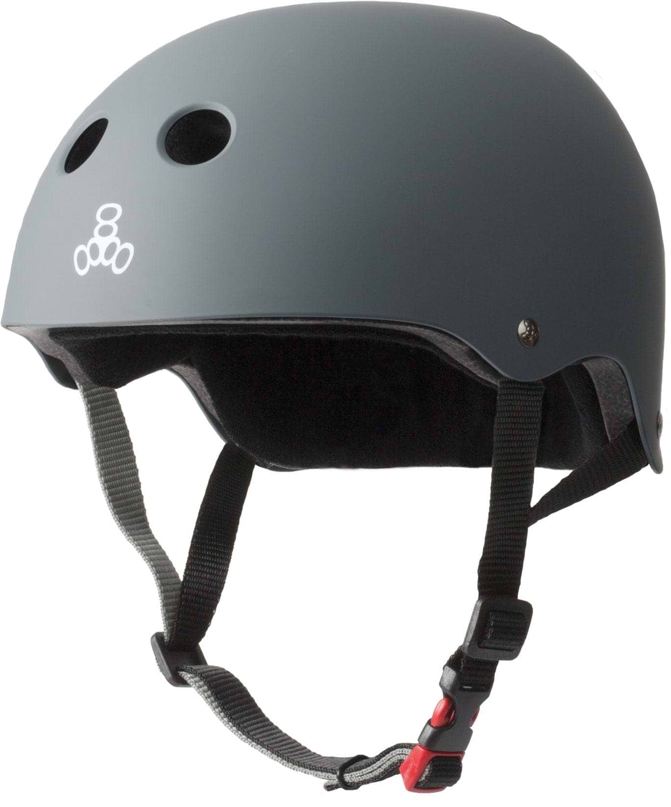 Introducing the Triple 8 Certified Sweatsaver Skate Helmet - Carbon by Triple 8. This helmet features a sleek gray matte finish with ventilation holes and adjustable black straps that include a distinctive red buckle. The side is adorned with a simple white logo, showcasing three interlocking circles. Designed to deliver dual-certified protection, it ensures superior high-impact absorption, making it perfect for both cycling and skating adventures.