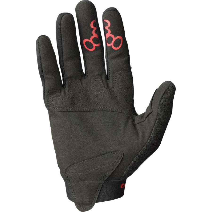 Introducing the Triple 8 ExoSkin Skate Protection Gloves in Black by Triple 8, showcasing a sleek design with a striking red abstract pattern on the index and middle fingers. These gloves boast reinforced stitching and palms, along with a textured grip, making them ideal for outdoor activities.