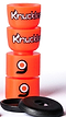 Orangatang Knuckles Orange Longboard Bushings feature a vibrant orange design with black logos, showcasing their high-rebound formula, alongside two black response pads in the foreground.