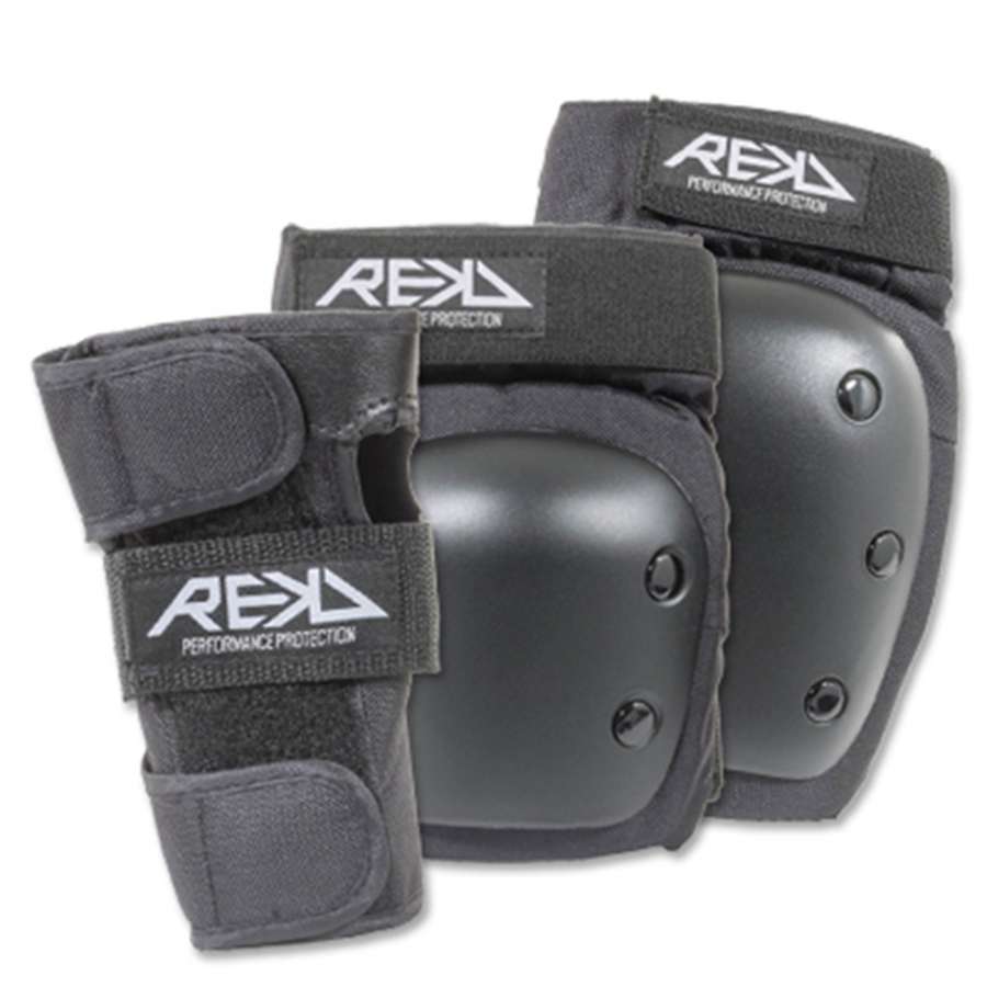 The REKD Heavy Duty Triple Skate Protection Pad Set in black includes knee and elbow pads, as well as wrist guards. Designed by REKD for optimal knee protection, they feature adjustable straps and a hard outer shell with the brand's logo prominently displayed.