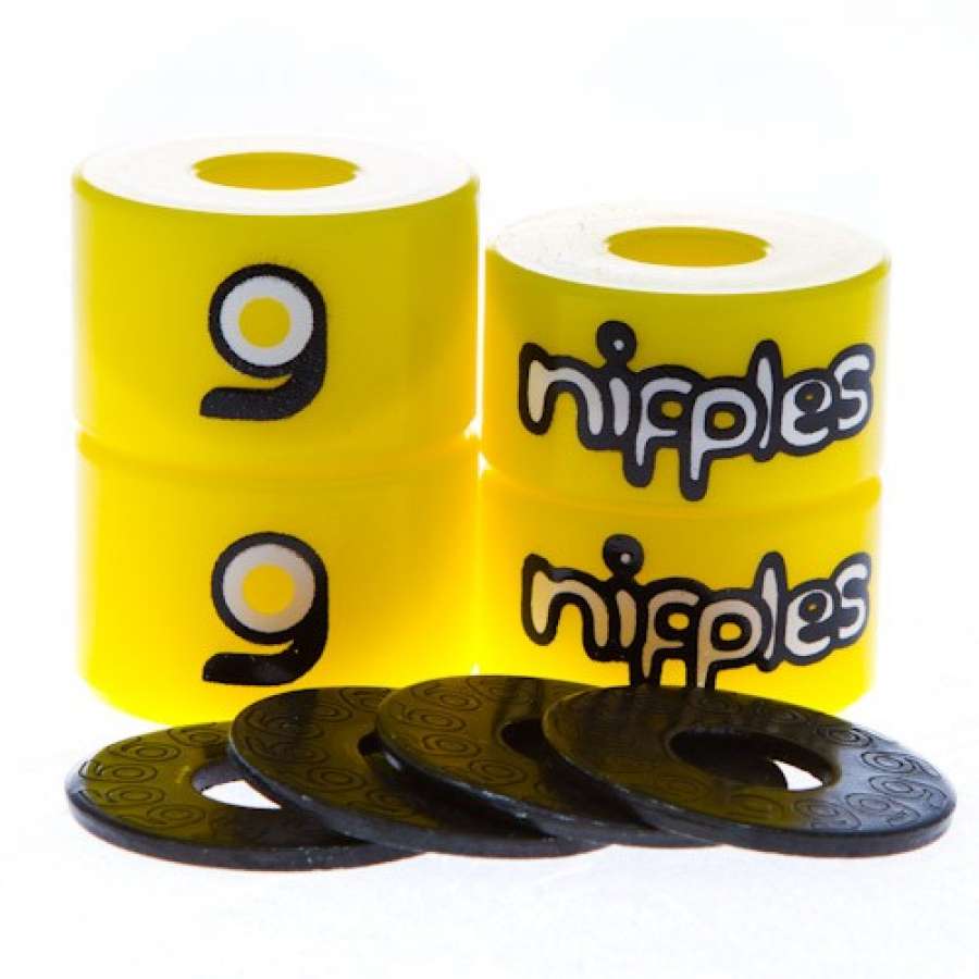 The "Orangatang Nipples" branding and circular logo adorn four yellow longboard bushings, arranged in pairs. Made from high rebound urethane, these bushings are ideal for carving and freestyle. Below them, a semicircle of black washers is neatly displayed.