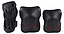 Introducing the SFR Essentials Junior Triple Skate Protection Pad Set - Black: an entry-level protection kit set against a white backdrop. This sleek black gear includes knee pads, elbow pads, and wrist guards with red accents, enhanced with impact caps for added safety. Perfect for young thrill-seekers!