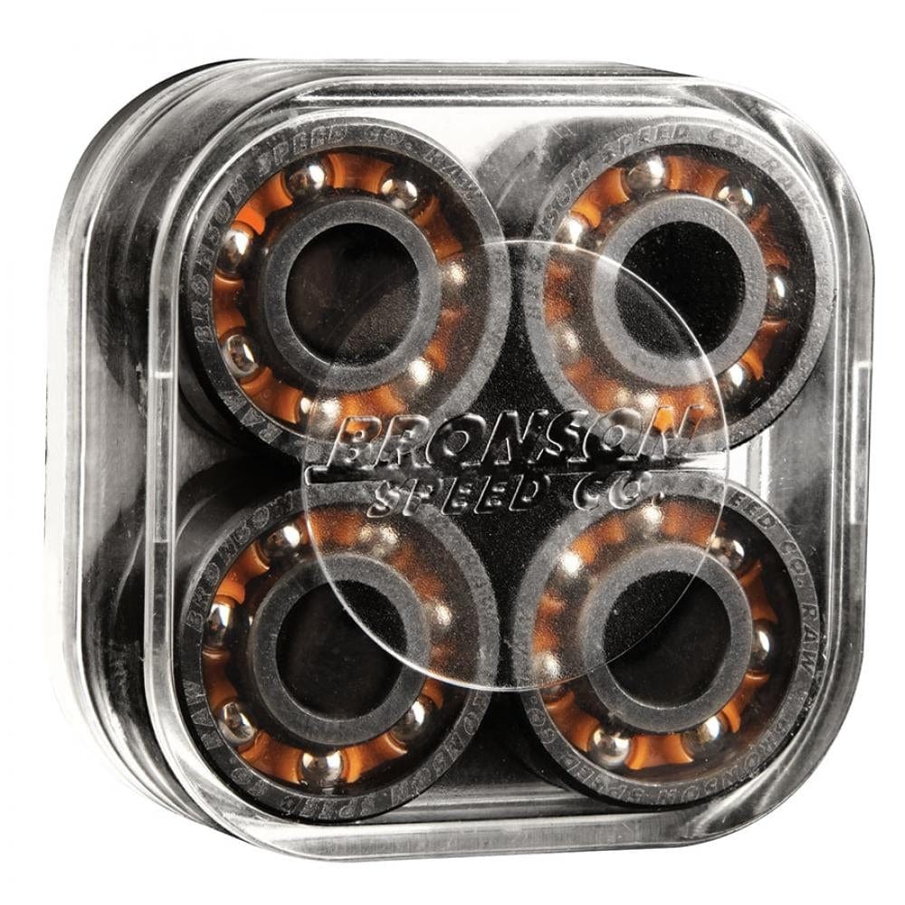 A pack of Bronson Speed Co. RAW skateboard bearings includes shieldless bearings with tungsten-coated races for enhanced durability. The transparent case holds eight circular bearings featuring orange and black details, with the Bronson brand name embossed on the lid, guaranteeing quality with their audible speed technology.