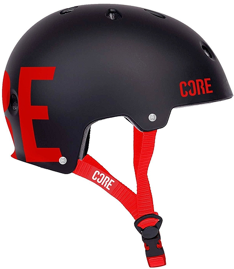 Introducing the CORE Street Skate/Scooter Helmet in Black and Red, showcasing bold "CORE" lettering on the side. This helmet features a classic skate design with ventilation holes, an adjustable red strap, CORE Lux Pads for enhanced comfort, and a quick-release buckle for effortless style.