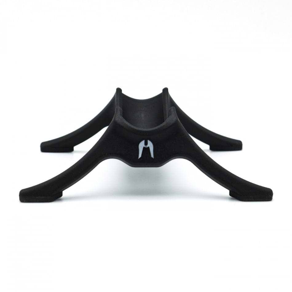 The Ethic DTC Classic Scooter Stand in black features a minimalist design with four curved legs and a central groove, specifically crafted to securely hold an Ethic Scooter, displayed against a white background.