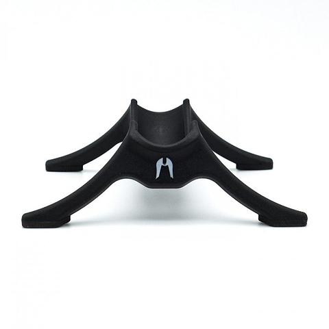 The Ethic DTC Classic Scooter Stand in black features a minimalist design with four curved legs and a central groove, specifically crafted to securely hold an Ethic Scooter, displayed against a white background.