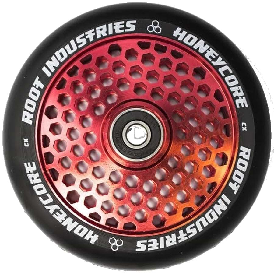 A detailed shot of the Root Industries Honeycore 110mm Stunt Scooter Wheel in Black/Red highlights its premium honeycomb cut-out design. This wheel features a metal core with hexagonal cutouts and displays the Root Industries branding around its outer black rubber tire, suggesting the superior quality of the Root bearings enclosed within.