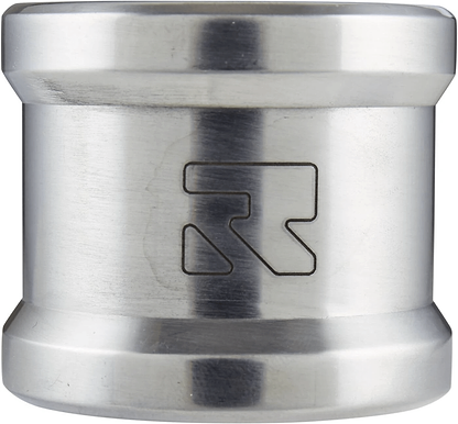 A chrome silver cylindrical object with a slightly tapered middle section, crafted from aircraft-grade aluminum. It features an engraved logo of Root Industries with a stylized "R" near the center. The surface is smooth and reflective, resembling the sleek design of a Root Industries Lithium 2 Bolt Oversized Stunt Scooter Clamp.