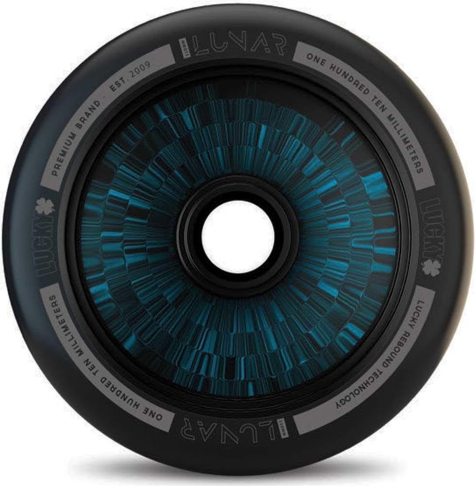The stylish Lucky Lunar 110mm Stunt Scooter Wheel, offered in a black and blue color scheme by the renowned brand Lucky, features a circular design ideal for scooter builds. The inner rim prominently displays the words "Lunar," "One Hundred Ten Millimeters," and incorporates the advanced "Lucky Rebound Technology." Its outer edge is crafted with a sleek, modern finish.