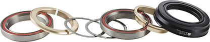 A row of various metal and plastic rings, featuring durable thrust bearings and seals for an integrated scooter headset, are aligned horizontally. Some rings have red inner linings, and one black seal prominently bears the "Lucky" branding from the Lucky Revo Integrated Stunt Scooter Headset - Black.