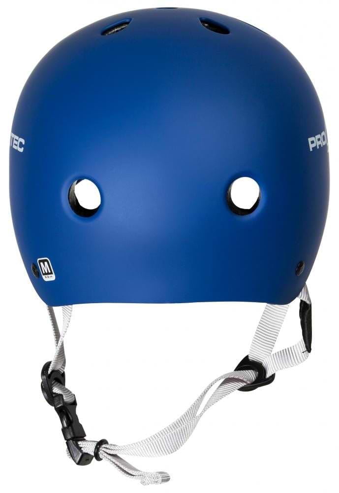The Pro-Tec Classic Certified Skate/Scooter Helmet in Matt Blue features ventilation holes, white chin straps, and a black buckle. It prominently displays "PROTEC" on the side and includes a size "M" sticker on the back, equipped with a high-impact absorbing ABS shell for superior protection.