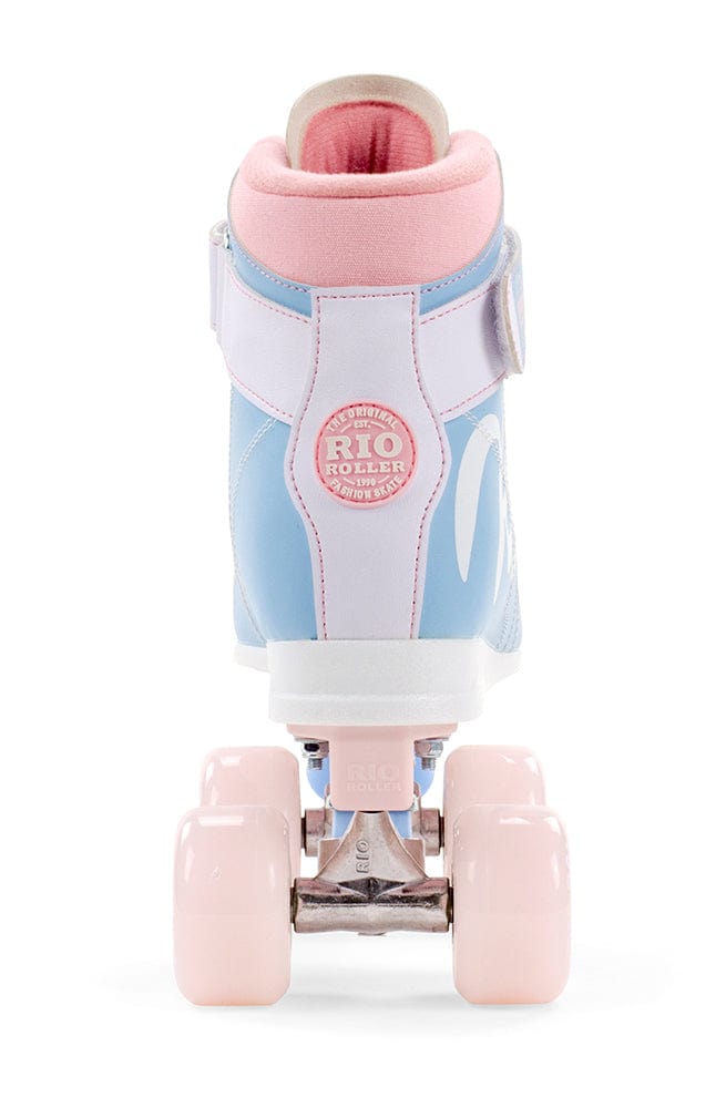 A single Rio Roller Milkshake Quad Roller Skate - Cotton Candy is displayed from the back, showcasing its vintage style in pastel blue and pink hues. The pink wheels enhance its design, while a round patch embossed with "Rio Roller" adorns the heel area. The figure skate style makes a striking impression against the pristine white background.