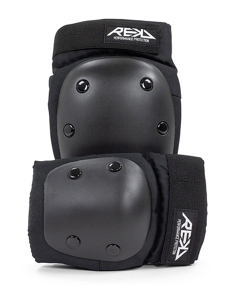 The REKD Youth Heavy Duty Double Skate Protection Pad Set in black offers superior protection with its hard shell caps and elastic straps, tailored for performance. The prominent "REKD" brand logo is displayed on the top of each pad, making it an excellent choice for action sports enthusiasts seeking dependable equipment.