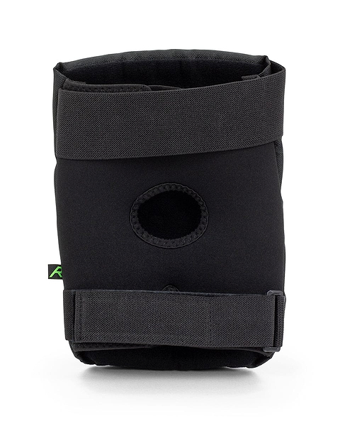 A pair of REKD Energy Ramp Skate Protection Knee Pads in black, designed with adjustable straps and an open patella design, stands upright against a white background. Integrated with impact foam, they provide enhanced support and protection during physical activities. Ideal for those seeking the reliability of the REKD brand.