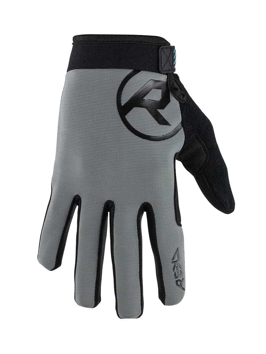 Introducing the REKD Status Skate Protection Gloves in Grey by REKD. These gloves showcase a sleek design with black trim and a logo on the back of the hand. They include a Velcro strap and a convenient loop for easy removal. The ergonomic fit provides comfort, while reinforced fingertips and thumb enhance durability. Additionally, the textured material on the palm improves grip for everyday tasks.