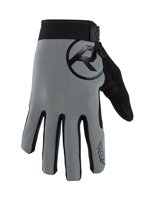 Introducing the REKD Status Skate Protection Gloves in Grey by REKD. These gloves showcase a sleek design with black trim and a logo on the back of the hand. They include a Velcro strap and a convenient loop for easy removal. The ergonomic fit provides comfort, while reinforced fingertips and thumb enhance durability. Additionally, the textured material on the palm improves grip for everyday tasks.
