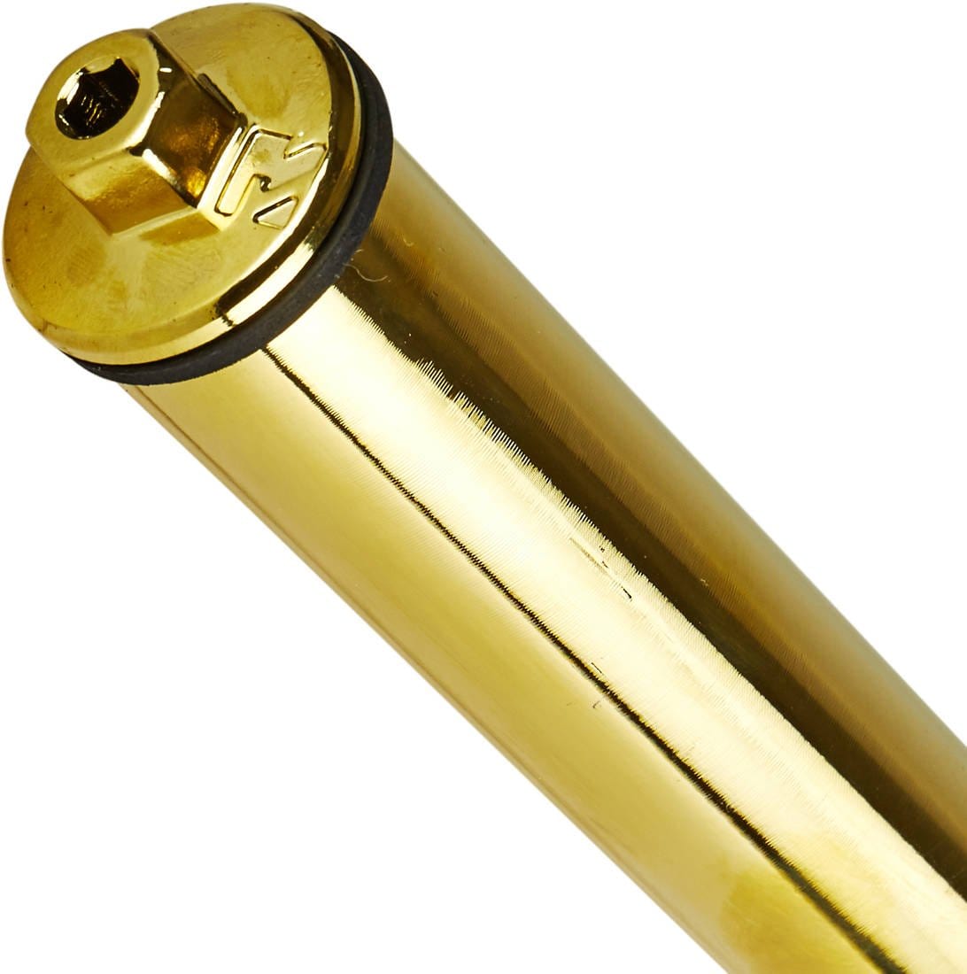 Close-up of a gleaming, gold-colored cylindrical object reminiscent of a part from the Root Industries AIR SCS/HIC Stunt Scooter Forks. Featuring a metal cap and rubber ring on one end, its polished surface reflects light beautifully. It might effortlessly belong to a lightweight scooter fork designed for compatibility with 120mm wheels from Root Industries.