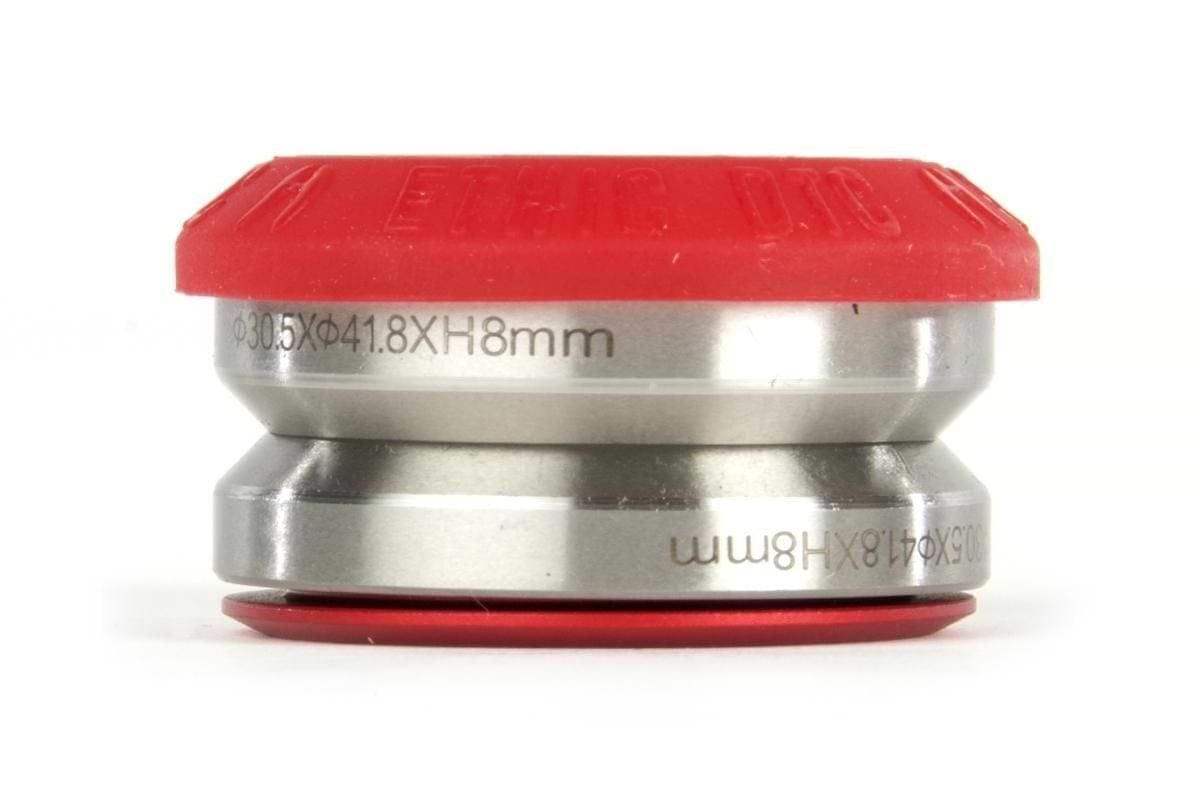 The Ethic DTC Silicone Integrated Stunt Scooter Headset in red, with its metal cylindrical body and intricate engravings, measures 30.5x41.8x8 mm and resembles parts commonly found in an Ethic DTC scooter headset. Its design suggests the presence of super smooth sealed bearings typical of high-quality setups, all depicted on a plain white background.