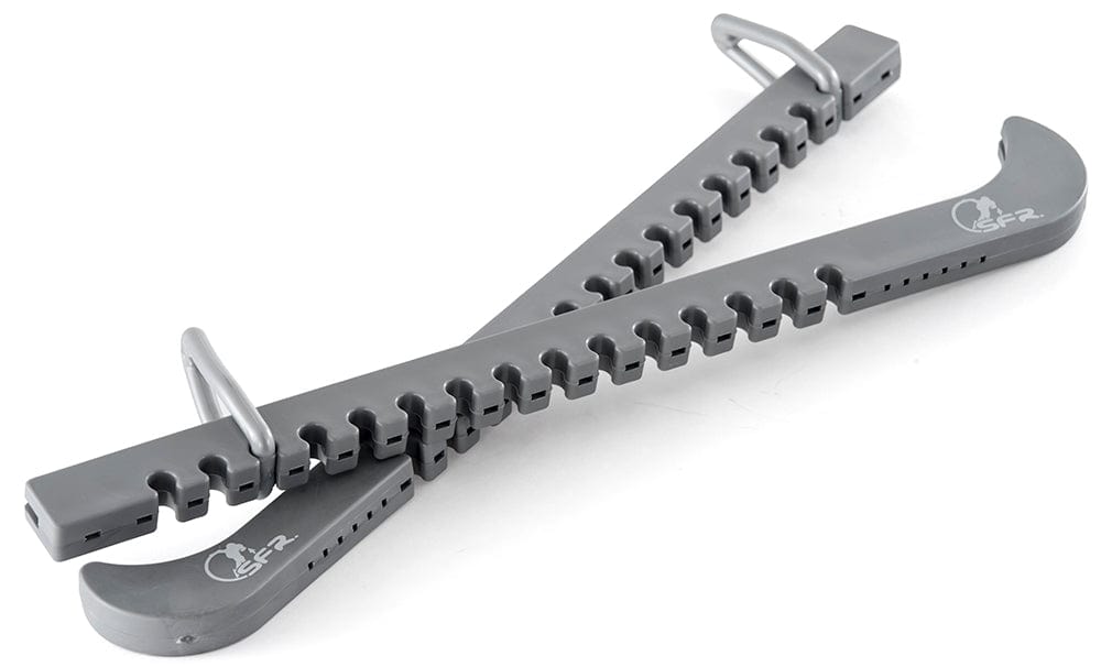 The SFR Figure Ice Skate Blade Guards in silver feature a sturdy sawtooth design with metal clips, arranged in a crisscross pattern on a white background, made from durable polypropene similar to that used in gray plastic snow shoe traction devices.