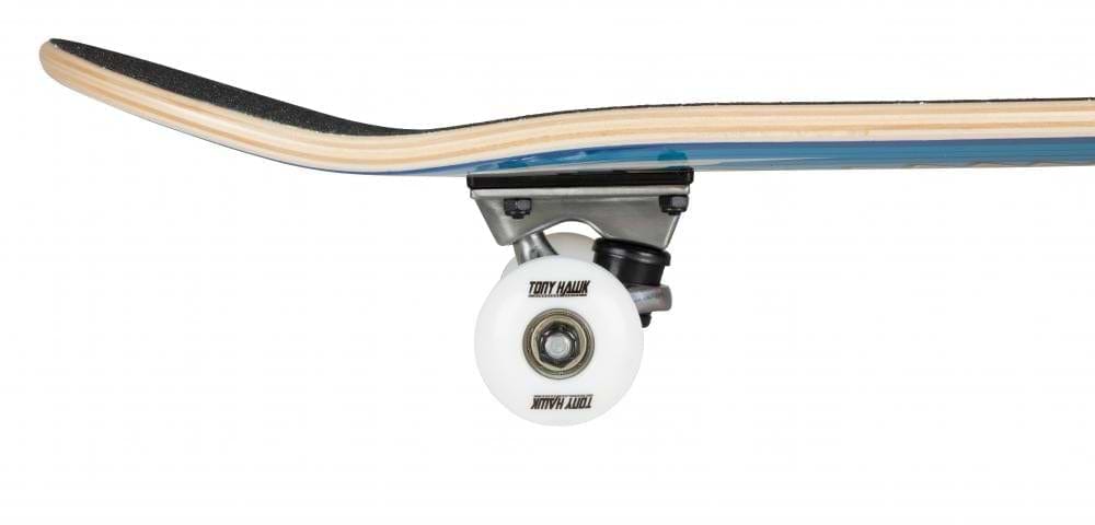 A close-up of the Tony Hawk 180 Series Wingspan Complete Skateboard's wheel and truck highlights the underside and part of the deck. The white wheel features text, and the board displays a blue and woodgrain finish with black grip tape on top, perfect for those seeking an entry-level experience.