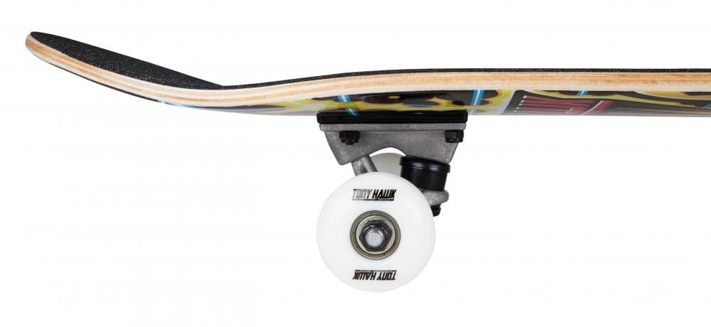 A close-up of the Tony Hawk 180 Series Arcade Complete Skateboard reveals a side view showcasing the deck, trucks, and a prominently branded white wheel with "Tony Hawk." Ideal for entry-level skaters, it boasts a vibrant deck design and visible grip tape on top.