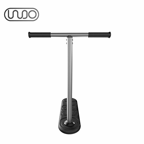 The INDO 570mm Indoor Trampoline Stunt Scooter - Black is a minimalist kick scooter designed for stunt scootering, featuring a T-shaped handlebar and two wheels, shown from the front against a plain white background. A distinctive logo with interconnected circles is displayed in the top left corner. Ideal for those looking to enhance their riding skills.