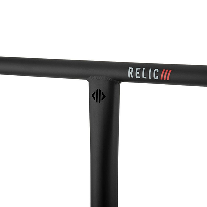 Close-up of the Drone Relic 3 Steel Oversized SCS Stunt Scooter Bars in black, crafted from durable Chromoly 4130 steel. The handlebar features the brand name "Drone" and three red lines near the top, showcasing a sleek, matte finish and a T-joint design for both style and resilience. Dimensions are 650mm x 600mm.