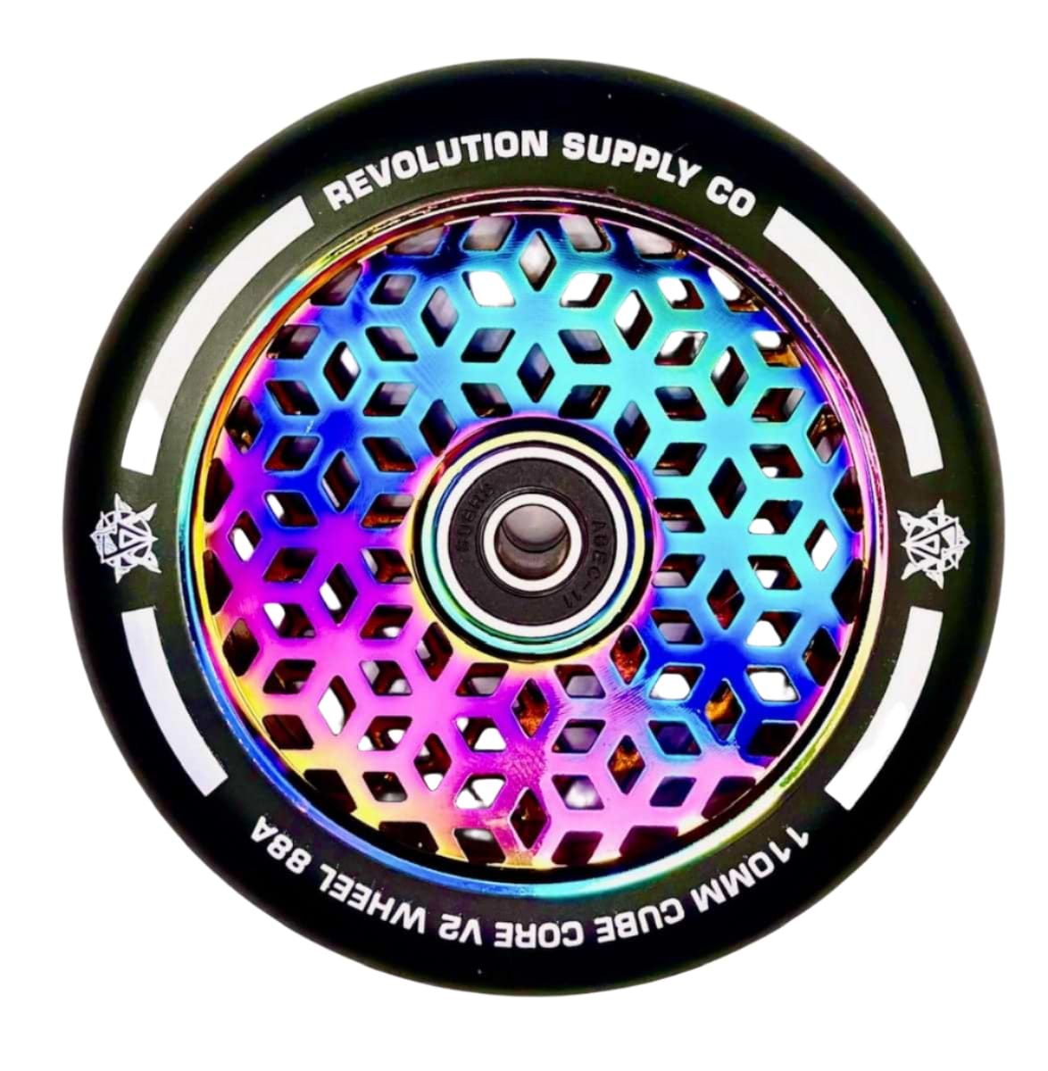 A detailed view of a vibrant scooter wheel displays a hexagonal honeycomb pattern, with the metal core boasting an iridescent rainbow sheen, highlighting Revolution's Cubed Core Ultralite design. The text encircling the wheel reads "Revolution" and "110mm Cube Core V2 Wheel 88A," representing the Revolution Cubed Core Ultralite 110mm Stunt Scooter Wheel in Neochrome Rainbow.