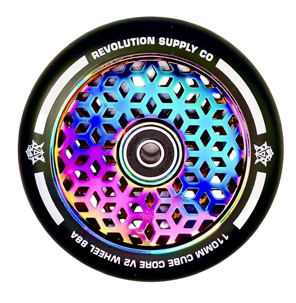 A detailed view of a vibrant scooter wheel displays a hexagonal honeycomb pattern, with the metal core boasting an iridescent rainbow sheen, highlighting Revolution's Cubed Core Ultralite design. The text encircling the wheel reads "Revolution" and "110mm Cube Core V2 Wheel 88A," representing the Revolution Cubed Core Ultralite 110mm Stunt Scooter Wheel in Neochrome Rainbow.