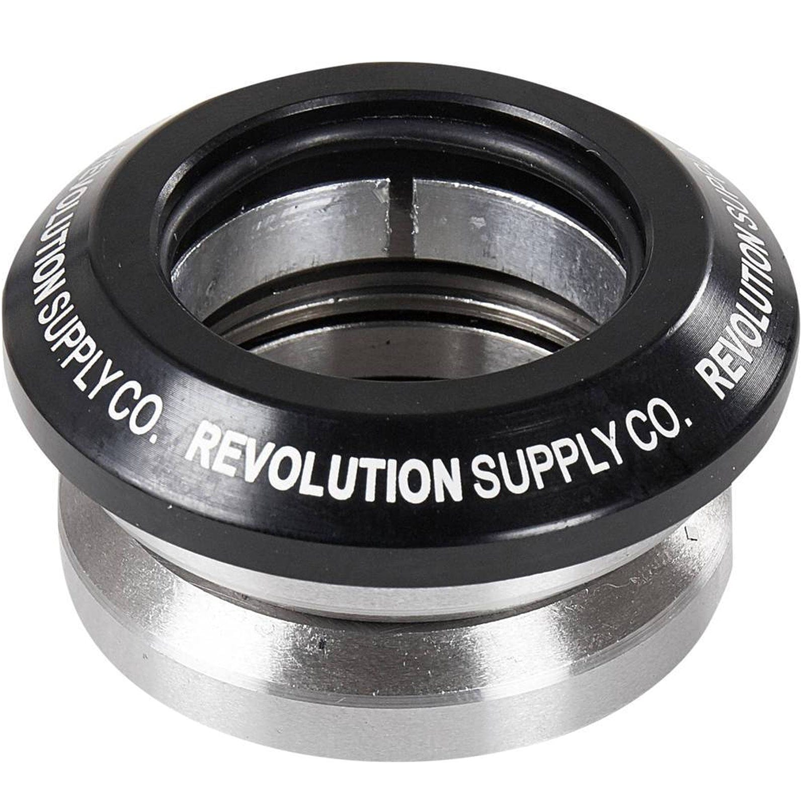 The Revolution Flow Integrated Stunt Scooter Headset in black, designed by Revolution, boasts a sleek black and silver component made from CNC milled aluminum. It elegantly displays the text "REVOLUTION SUPPLY CO." around the top edge. Equipped with sealed bearings, this headset ensures smooth rides.