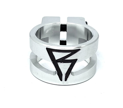The Revolution Super Lite 2 Bolt Oversized Stunt Scooter Clamp - Chrome highlights a geometric design with an eye-catching, black angular symbol that intertwines the letters "P" and "B." Made from durable 6061-T6 aluminum, this clamp boasts a minimalist chrome finish and a dependable threaded screw mechanism, delivering both style and functionality.