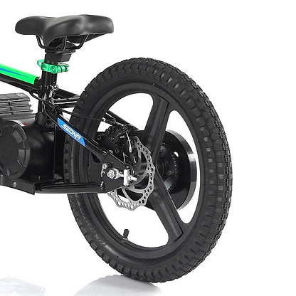 Close-up of the rear wheel of a Revvi 16" Plus Kids Electric Balance Bike - Green, showcasing its hybrid rubber air-filled tyres and disc brake. The bike has a black frame accented with green, and an electric motor is mounted on the wheel.