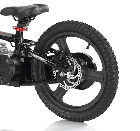 Close-up of the rear wheel and frame of a Revvi 16" Plus Kids Electric Balance Bike in red. The thick tire and disc brake accentuate the motor hub at the center, while a small portion of the seat and part of a red reflector can be seen, making it an ideal choice for youngsters seeking thrilling rides.