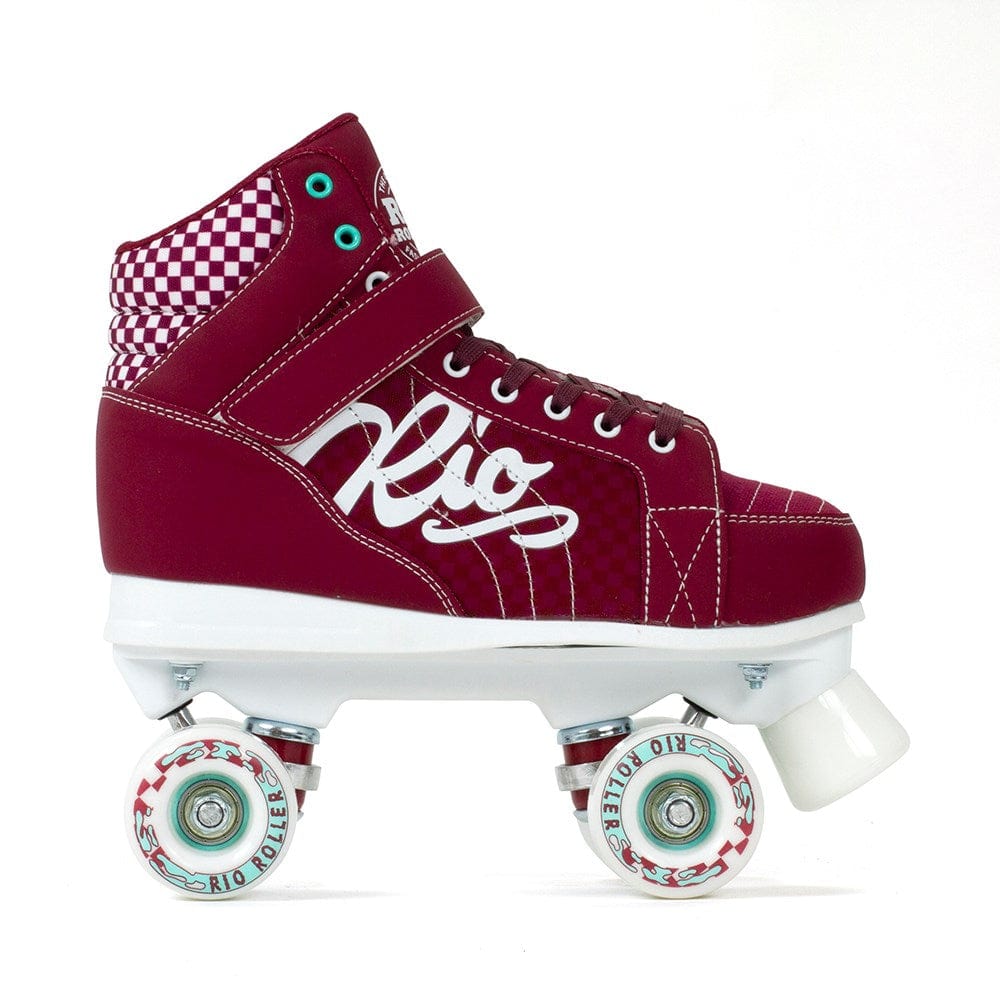 The Rio Roller Mayhem II Quad Roller Skates - Red, crafted in a roller derby style, showcase a checkered ankle pattern and feature the iconic "Rio" logo. The durable Hi-Impact Chassis paired with a white sole is highlighted by four white wheels accented with eye-catching red and blue details, capturing the essence of the Rio Roller Mayhem spirit.