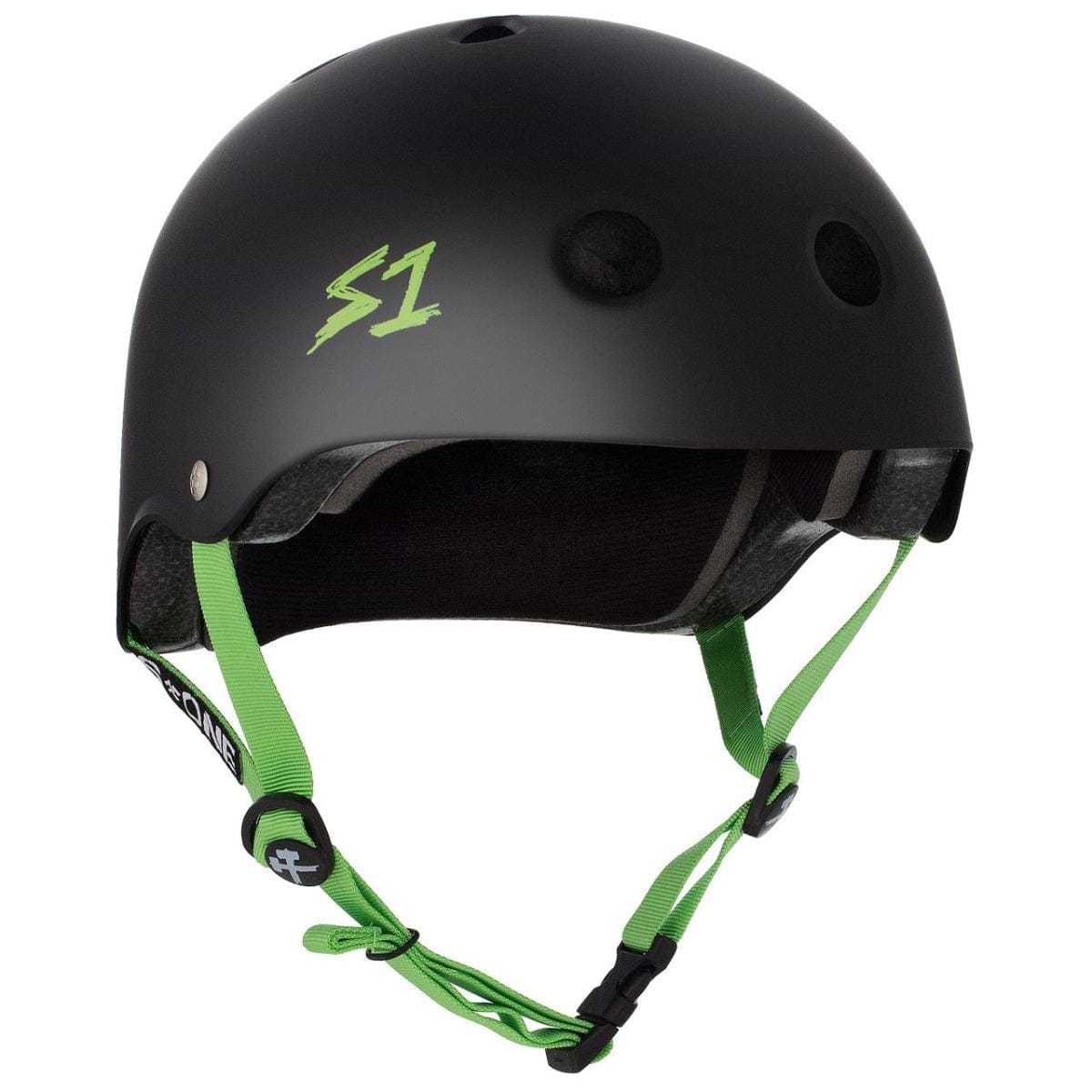 The S1 Lifer Skate / Scooter Helmet - Matt Black / Green is a protective helmet designed by S1, featuring a sleek black exterior with a distinctive green "S1" logo on the side. This helmet offers green adjustable straps, a secure black buckle system, EPS Fusion Foam for enhanced safety, and ventilation holes for maximum airflow.