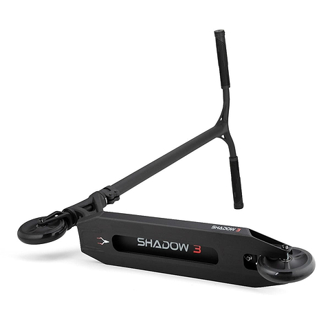 Introducing the Drone Shadow 3 Feather-Light Complete Stunt Scooter in Black, showcasing a minimalist design with "SHADOW 3" gracing its deck. It features Helios Hollow-Spoked Wheels and a T-shaped handlebar. This feather-light, sleek scooter leans against a plain white backdrop, epitomizing modern simplicity.