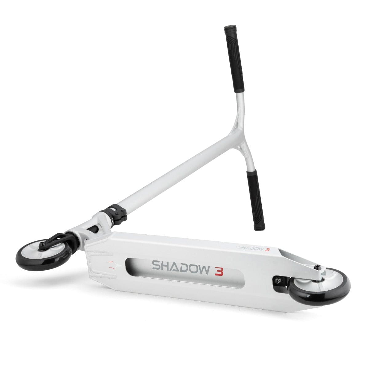 A silver anodized scooter from Drone, featuring a Y-shaped handlebar, is displayed on its side with the "Drone Shadow 3" design boldly visible on the deck in black and red. This Feather-Light Complete Stunt Scooter includes two small black Helios hollow-spoked wheels and comfortable black grips on the handles.