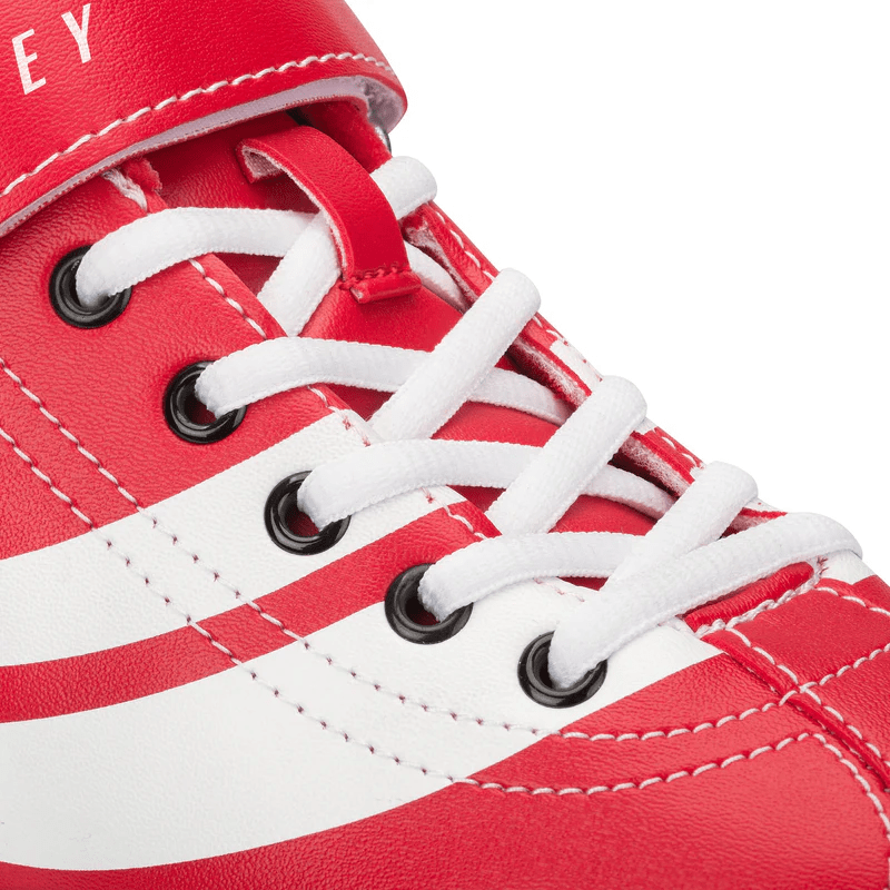 Close-up of a red and white sneaker inspired by Osprey Disco Quad Roller Skates - Red by Osprey, featuring white laces in black eyelets, white side stripes, and visible stitching on the leather.