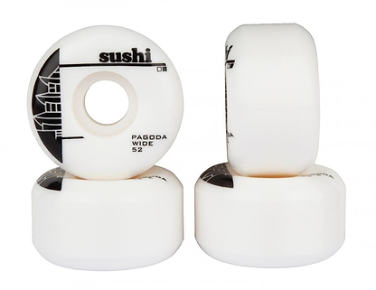 Two columns of four white skateboard wheels branded "Sushi" are stacked, with one wheel standing upright, displaying its label "Pagoda Wide 52mm 99A Skateboard Wheels - White / Black" along with a pagoda graphic. The other wheels are stacked horizontally, highlighting their high-quality SHR Urethane material ideal for skateboard enthusiasts.