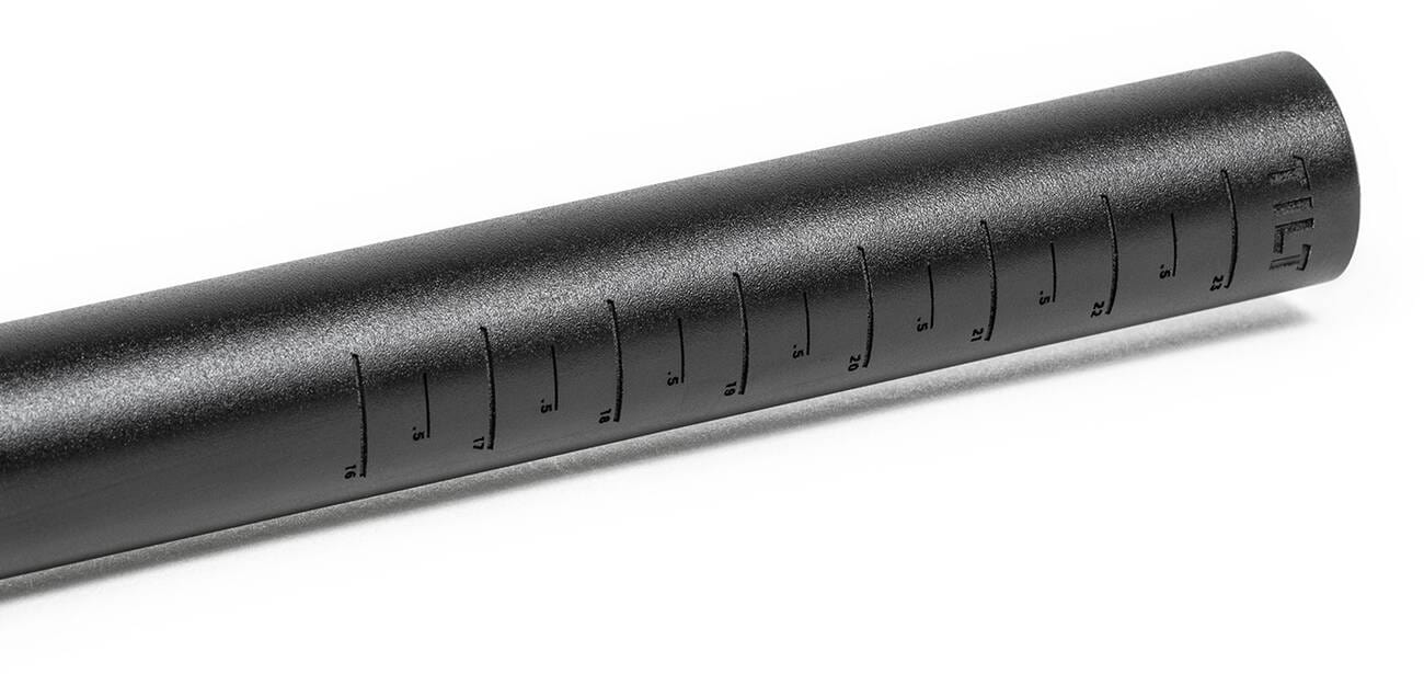 Close-up of a black, cylindrical shotgun microphone crafted from cold-formed aluminum, showcasing ridged sides and the brand name "Tilt" engraved near one end.